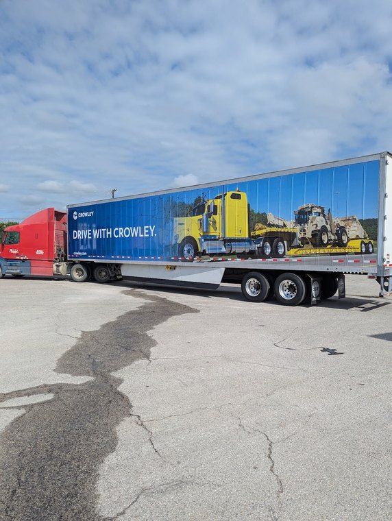 Enclosed trailer wrap with equipment graphics